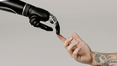 A robotic hand and a human hand reaching toward each other